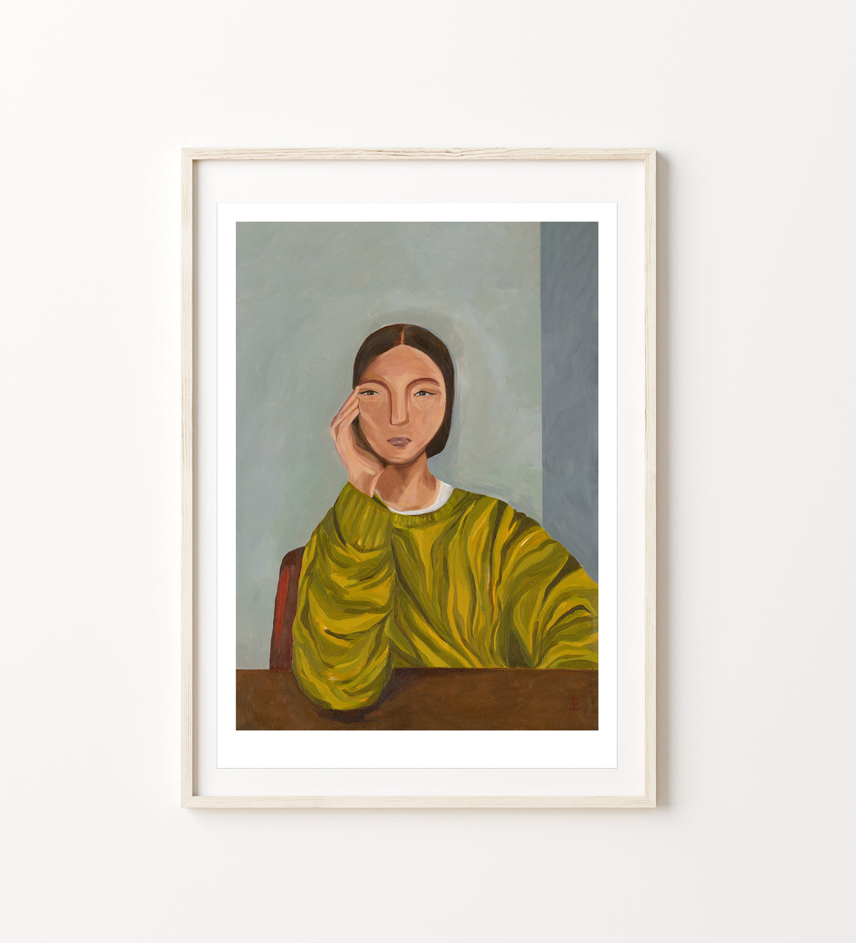 Framed artwork of a woman in a green jumper 