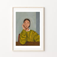 Framed artwork of a woman in a green jumper 