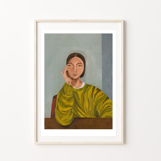 Framed artwork of a woman in a green jumper 