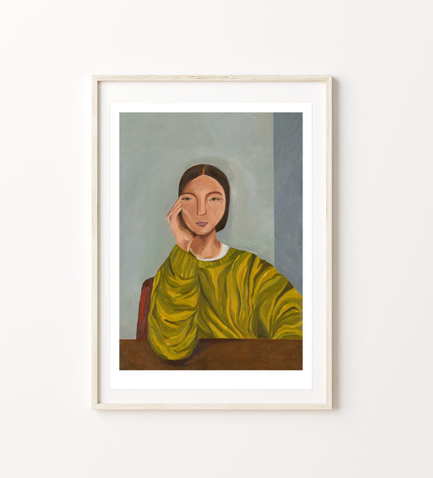 Framed artwork of a woman in a green jumper 