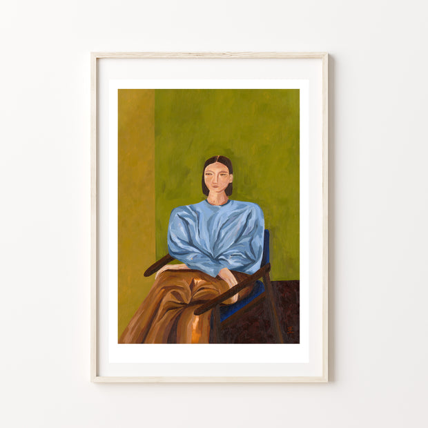 Framed painting of a person wearing a blue shirt and brown pants sat on a chair